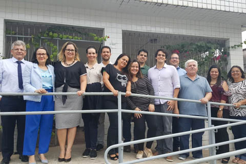 Fotografia de 13 pessoas, em pé, olhando para a câmera