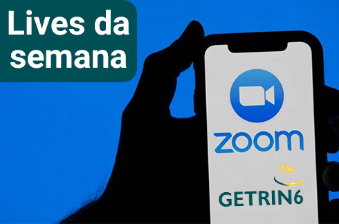 Mão segurando um celular onde está escrito Lives da Semana - Getrin6, Zoom&quot;