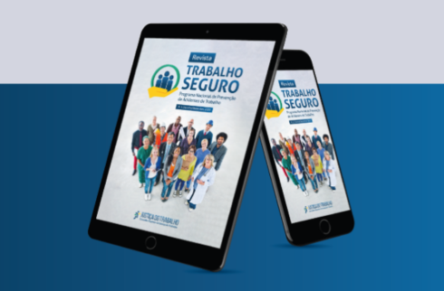 Imagem de um tablet e um celular com a revista do trabalho seguro aberta na capa