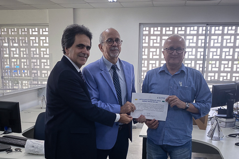 Foto do corregedor entregando diploma da premiação