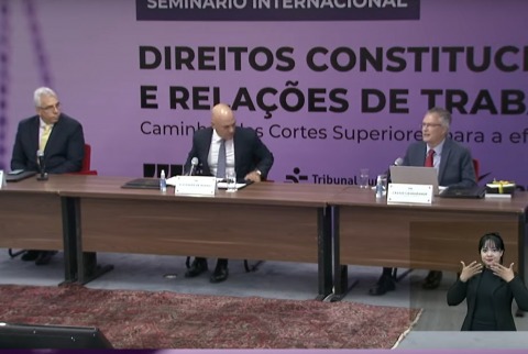 Três autoridades sentados à mesa de honra do seminário Direitos Constitucionais e Relações de Trabalho