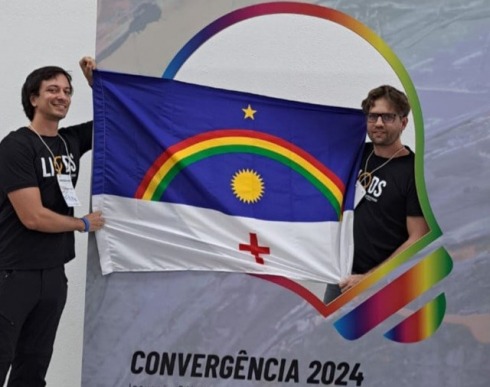 Foto dos servidores Ricardo Scholz e Filipe Guerreiro segurando a bandeira de Pernambuco