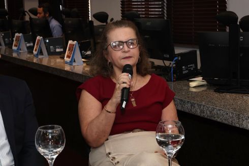 foto mulher sentada falando ao microfone