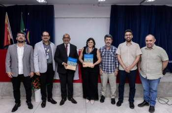 Foto dos/das participantes do encontro ladeados/as